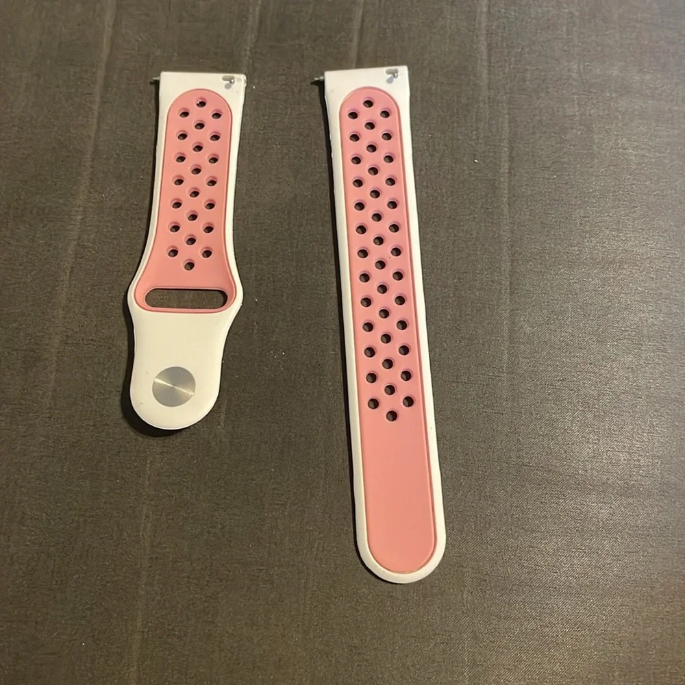 Pink and white Fitbit versa band